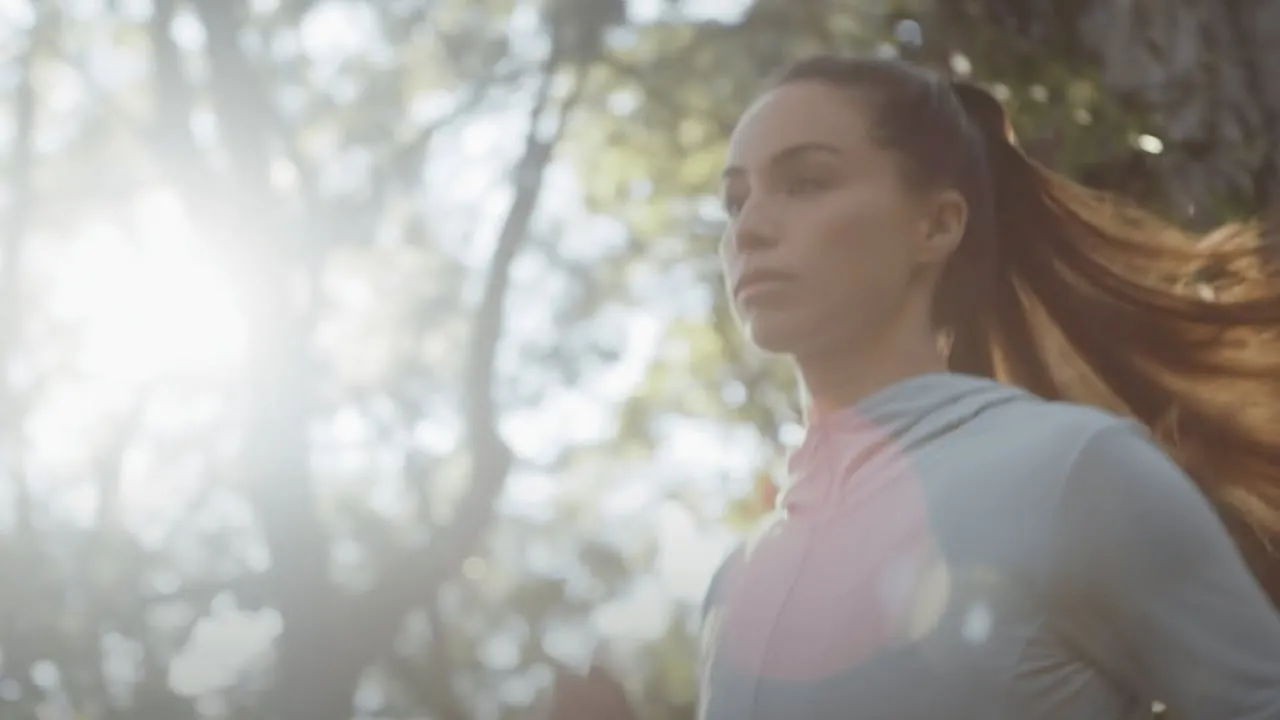 Still from the MODOC promo video — an athlete running through a sunlit forest.