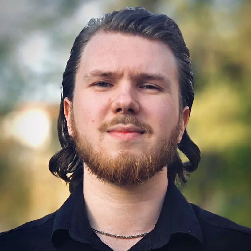 Jan Duras outdoors in a black shirt, professional portrait